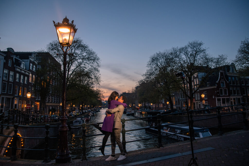 couple dancing in the evening on Duifbrug in Amsterdam overlooking the Canal.