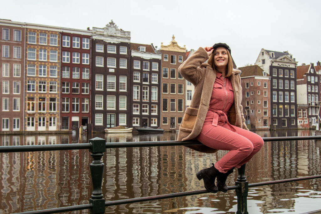 Girl posing by Canal on Rokin Amsterdam.