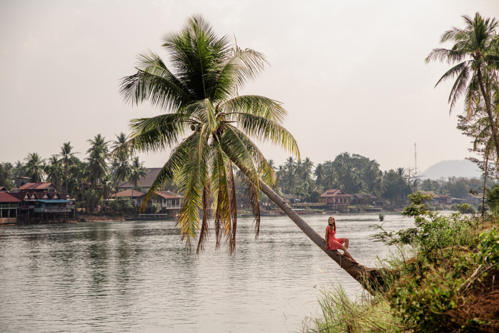 Girl sitting on palmtree in Don Det 4000 islands Laos