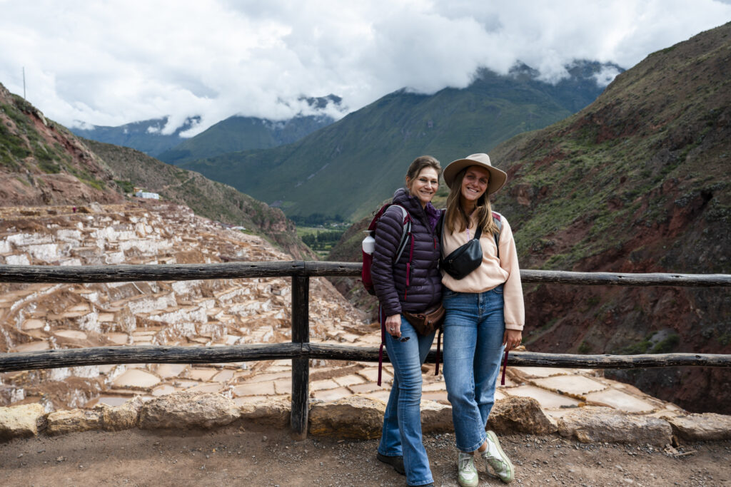 me and my mom in front of Maras Salt Mines terraces in peru 