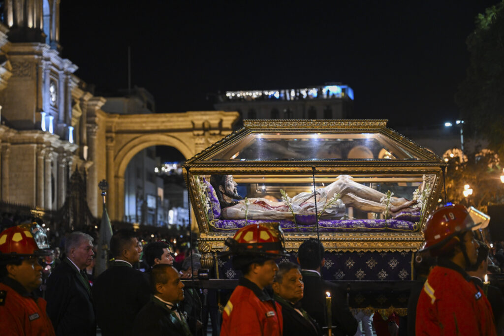 People carrying casket with Jesus during Holy Friday procession in Arequipa, Peru