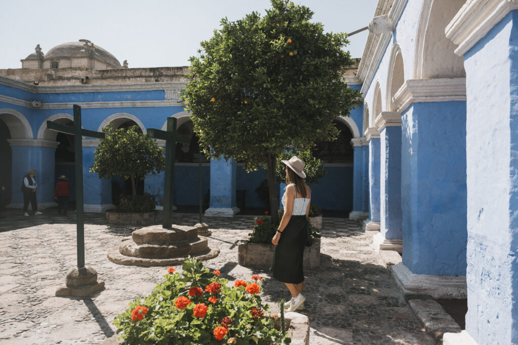 girl walking through courtyard in Santa Catalina Monastery in Arequipa, Peru 