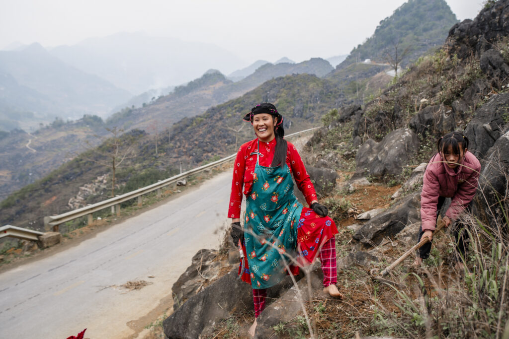 woman working on a mountain in the Ha Gian Loop, Vietnam