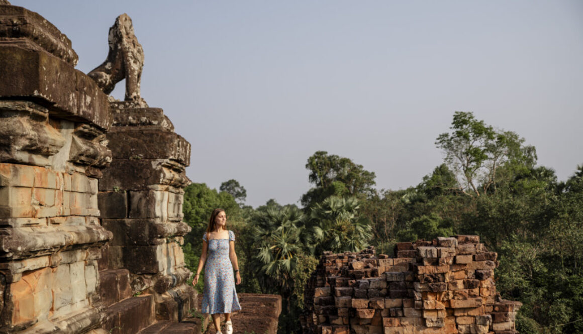 girl walking on the pre run temple in Angkor during sunrise.