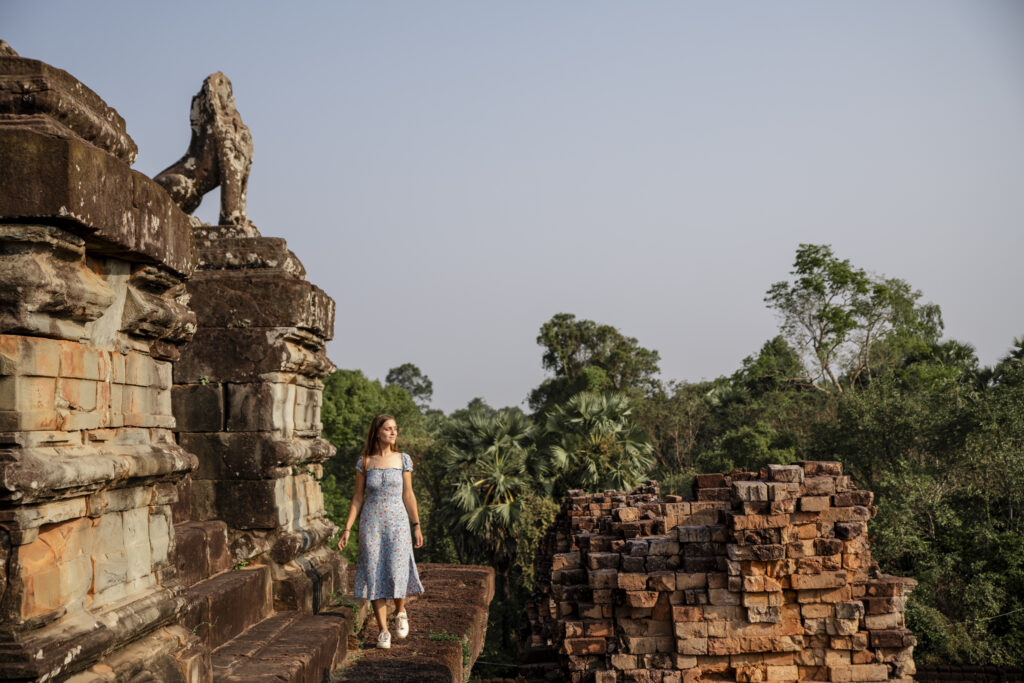 girl walking on the pre run temple in Angkor during sunrise. 