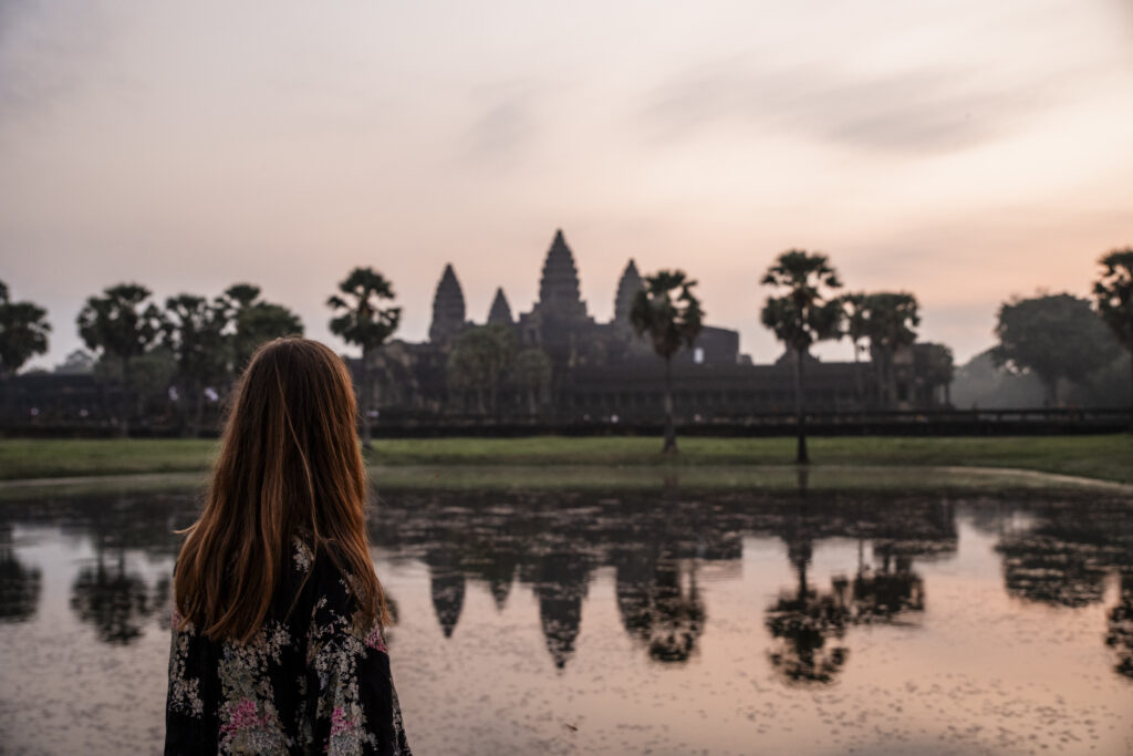 Girl watching the sunrise at Angkor Wat, Cambodja