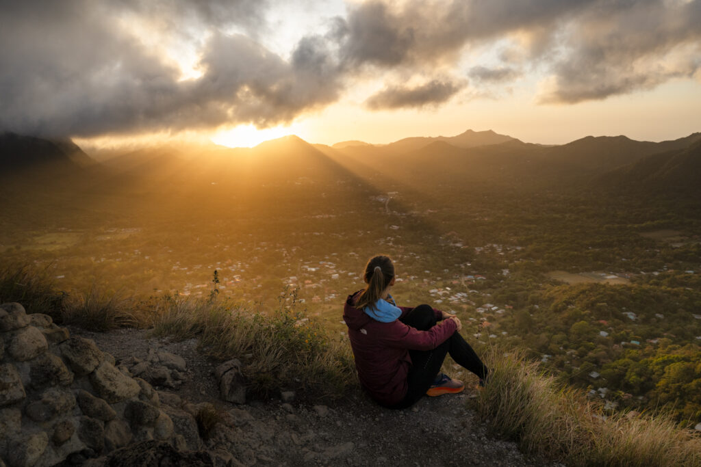 girl watching the sunrise at la india dormida in Valle de Anton, Panama