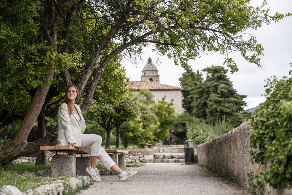 Girl sitting in the gardens of Monastery de Cimiez in Nice, France