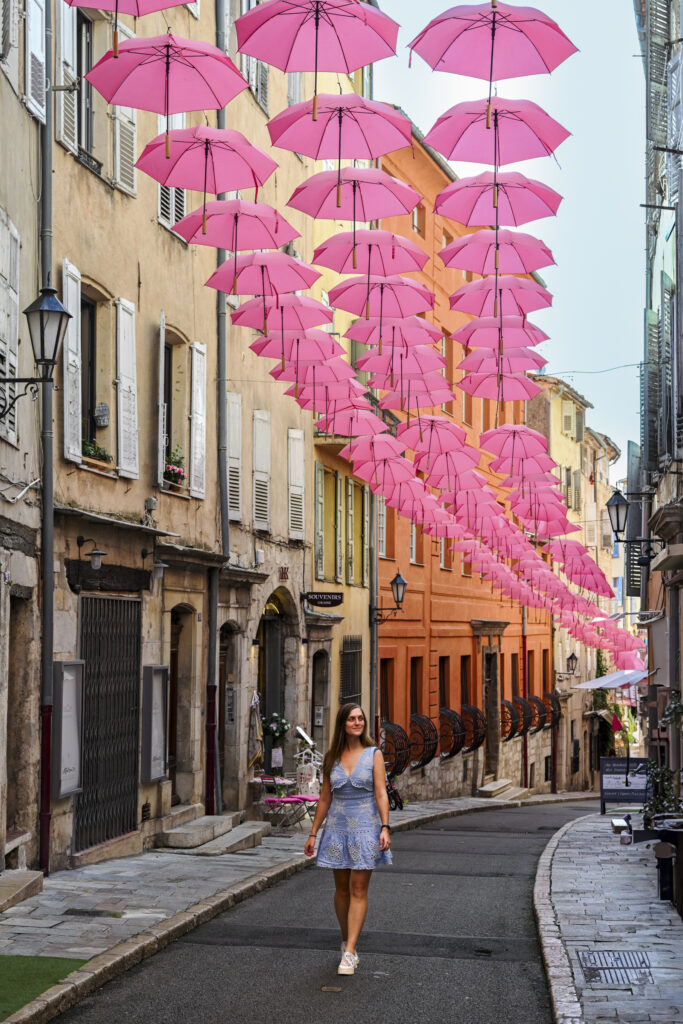 street with pink umbrella's in Grasse, village in the French Riviera